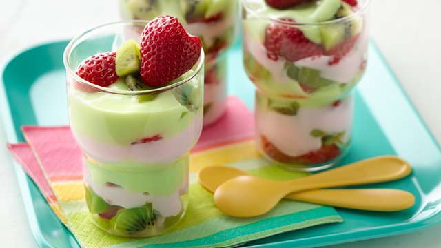 pink and green layered yogurt parfaits in clear glass cups