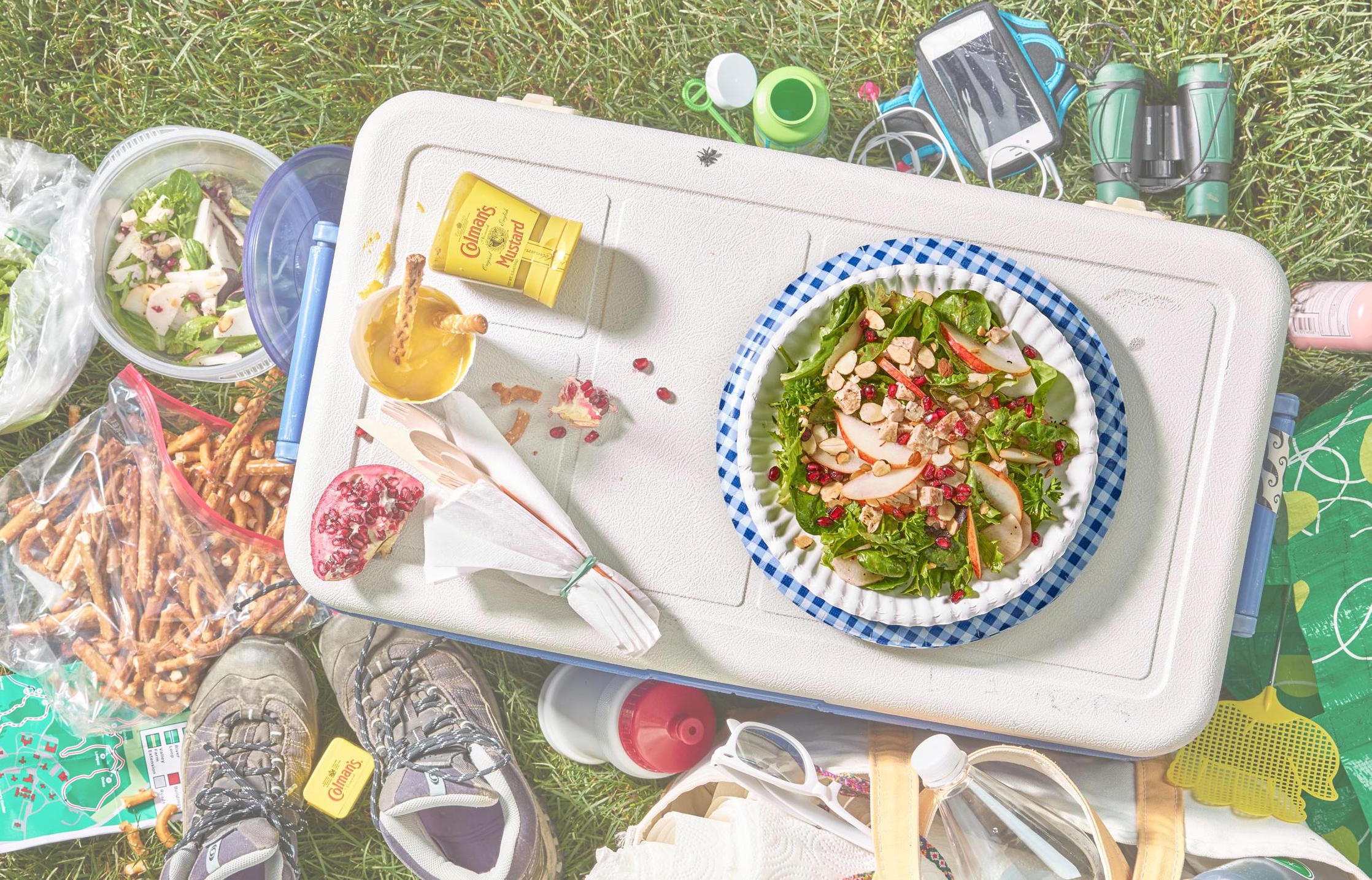chicken salad in a bowl as a centerpiece on a picnic blanket in the grass