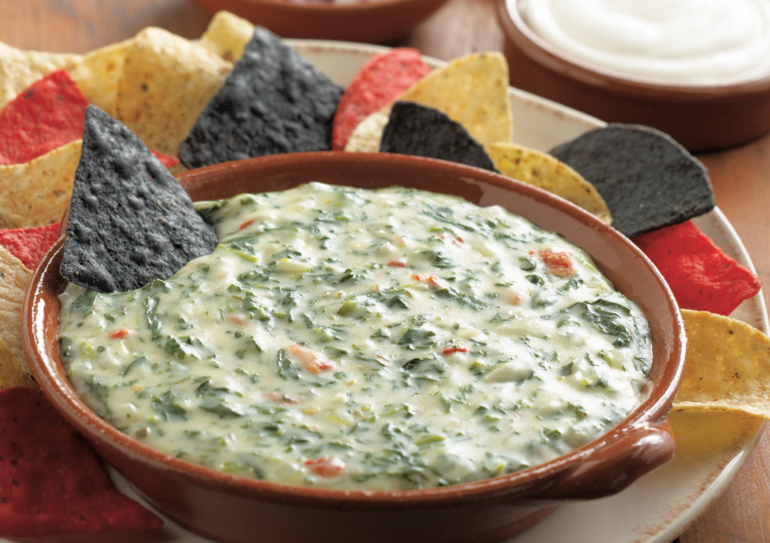 Score a touchdown at the snack table with this hearty spinach dip from Daisy Brand, made with pimento peppers, pepper jack and Monterey jack cheese.