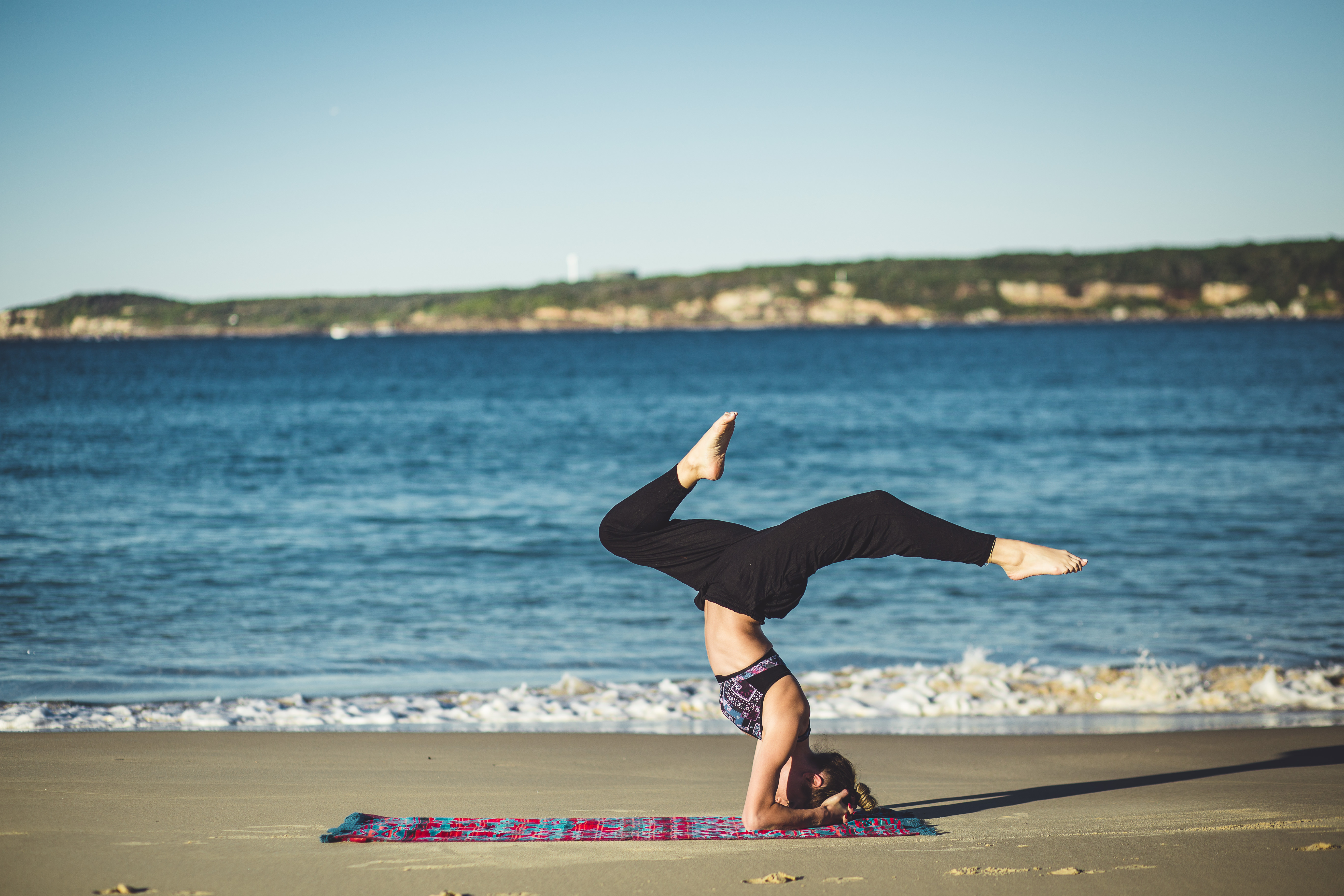 headstand yoga pose on the beach