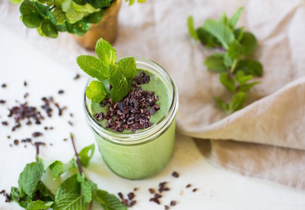 healthy green shamrock shake with chocolate shavings in a glass jar