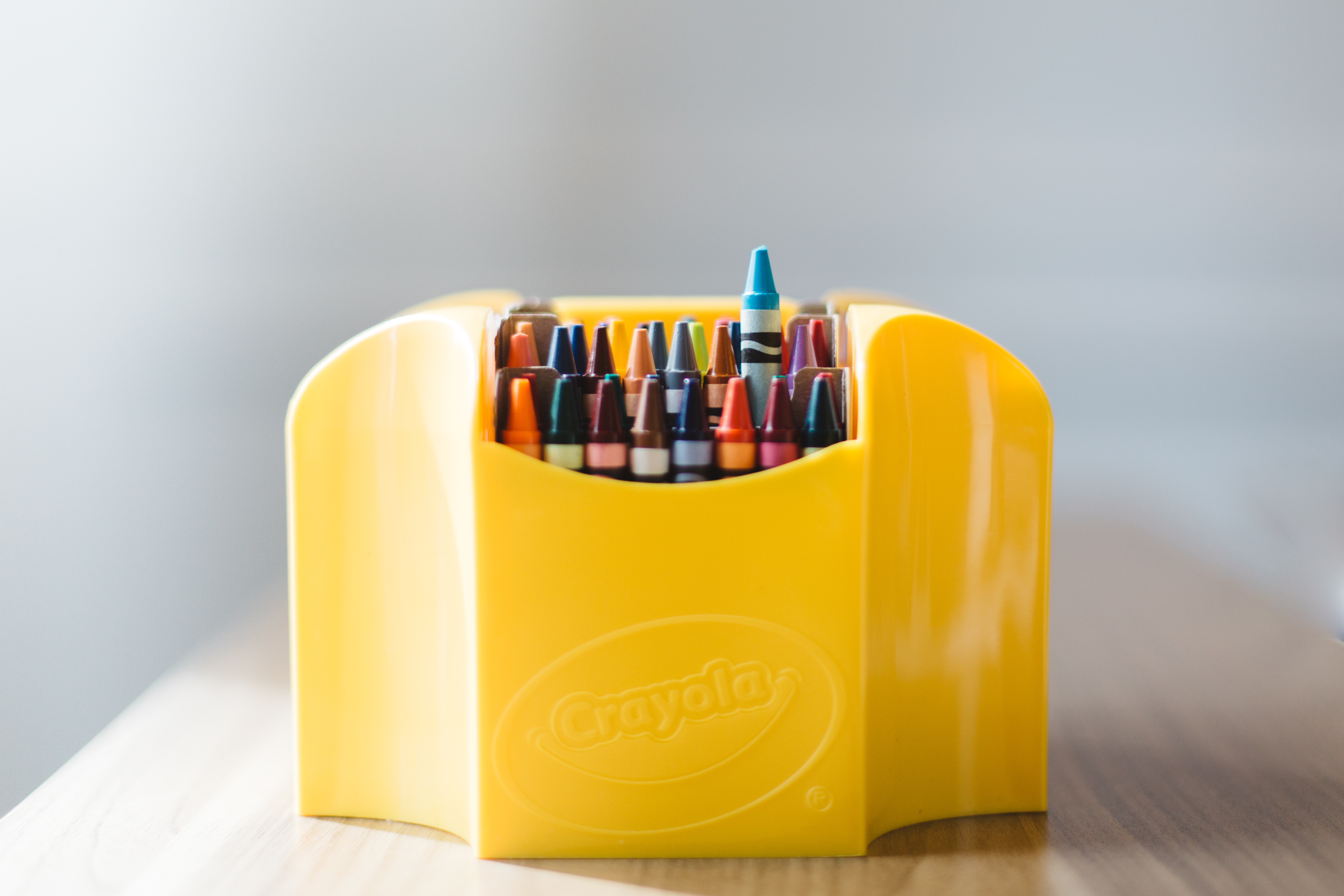 Yellow Crayola crayon holder with tons of colorful crayons inside