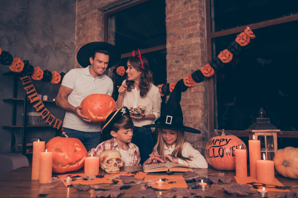 a family celebrating halloween with hats on