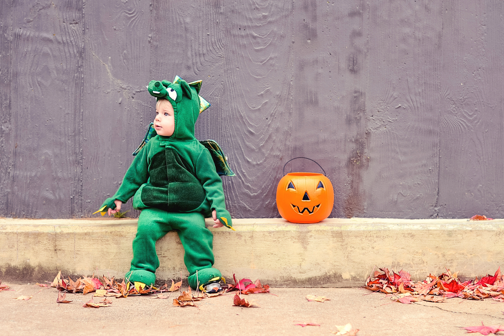 child dressed as green dinosaur