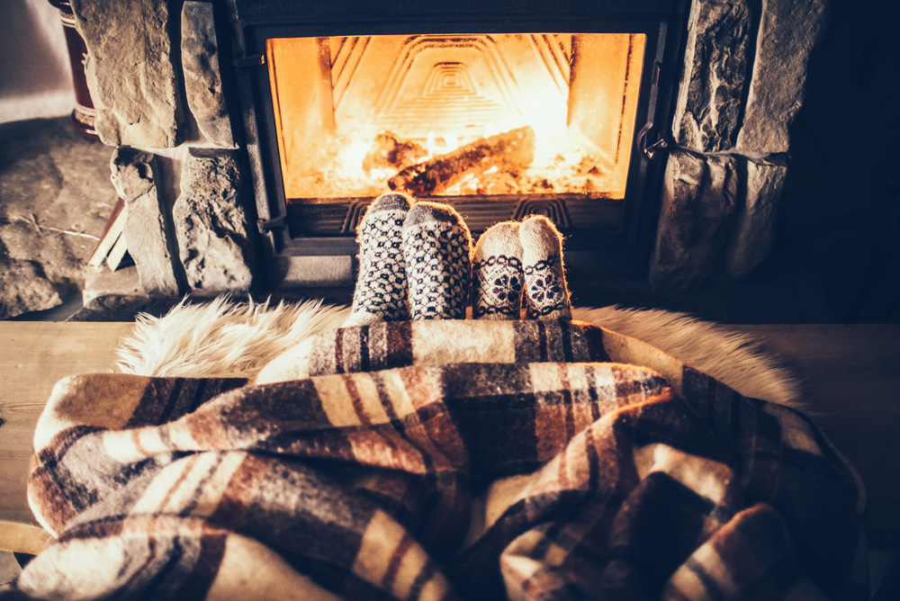 Socked feet cozy next to a warm fire