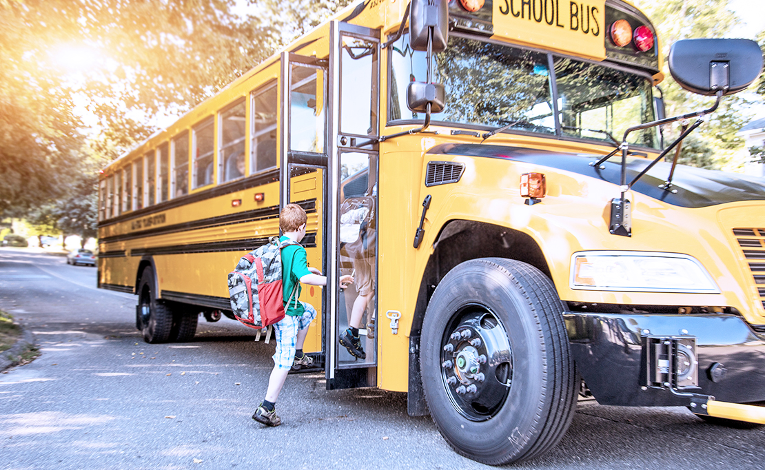 Children get on a schoolbus