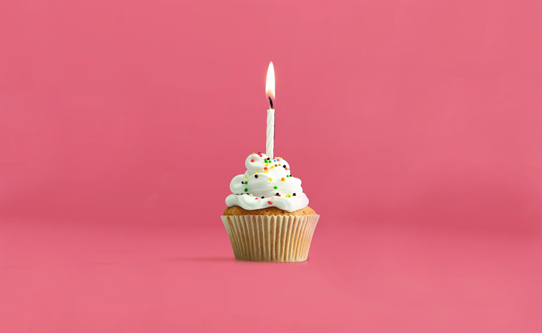 single cupcake with 1 candle, lit