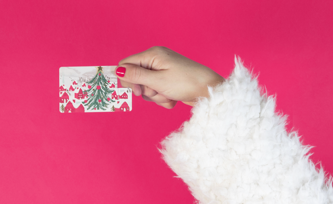 Woman holding a holiday gift card