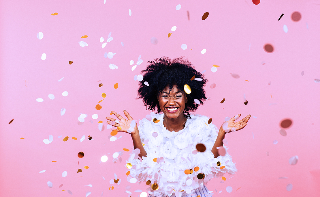 Woman celebrating Ibotta's $500 Million Moment with Confetti