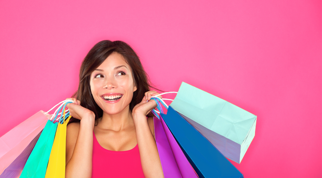 Woman enjoying shopping spree with shopping bags using IBotta