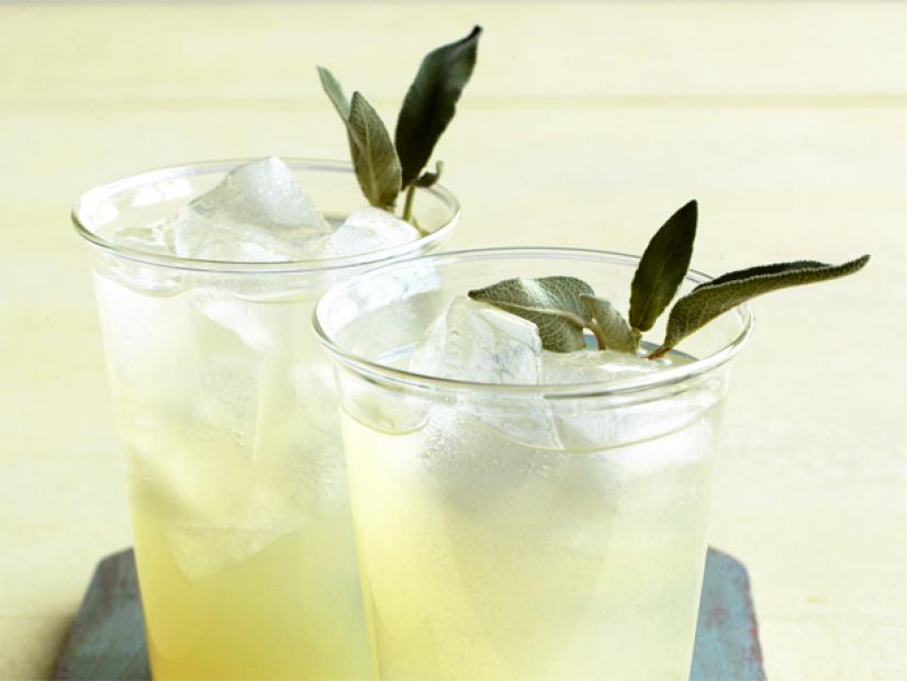 Two glasses of iced sage limeade with fresh sage leaves as garnish