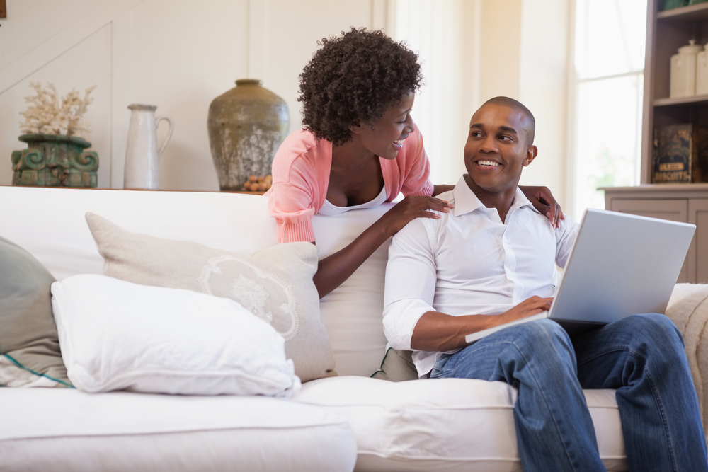 Man and woman using the free Ibotta Browser Extension at home