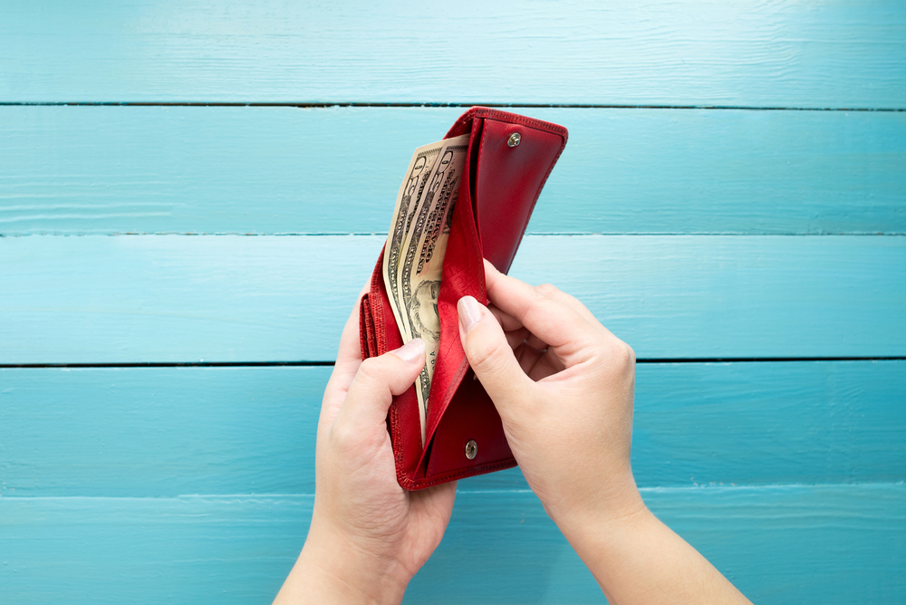 Man with wallet using Ibotta to help track and support spending habits