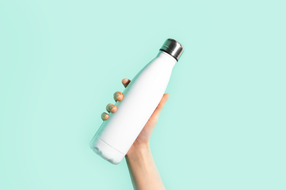 Woman holding up a reusable water bottle
