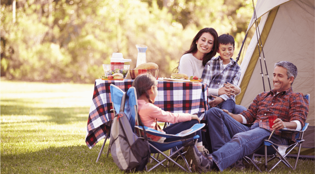 A family enjoying labor day with a picnic outside.
