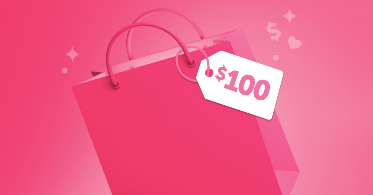 Pink gift bag with a $100 label on the tag in front of a pink background